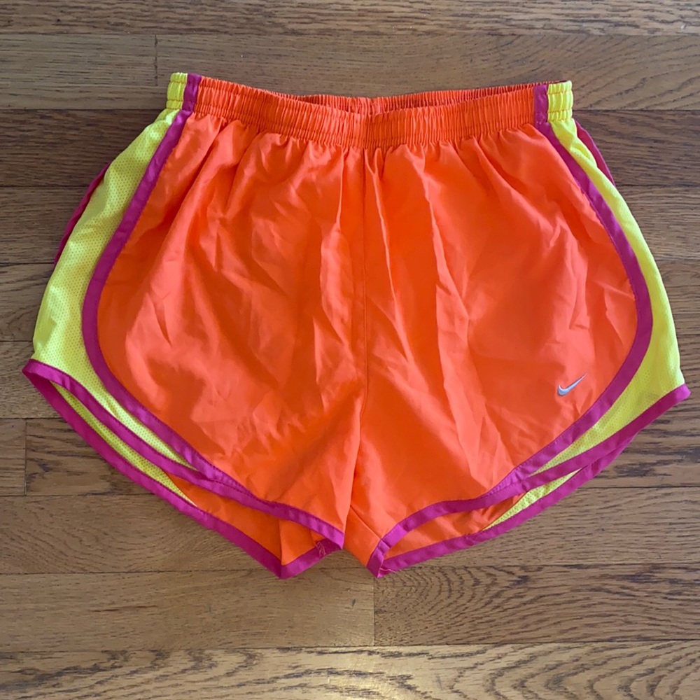 Bright orange Nike running shorts